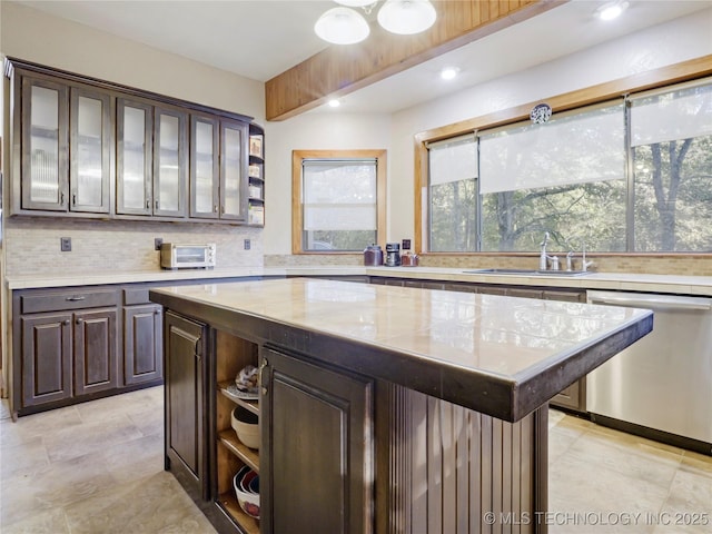 5792 W Lain Lake Rd, Atoka, OK 74525 - kitchen featuring stainless steel dishwasher, light countertops, dark brown cabinetry, a sink, and glass insert cabinets