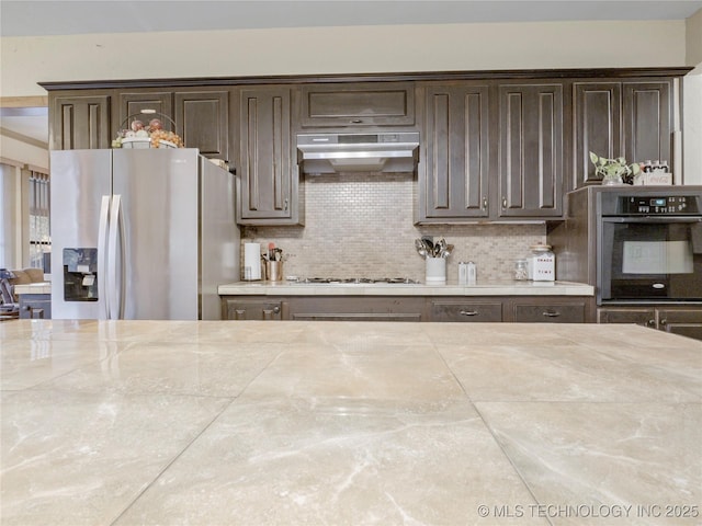 5792 W Lain Lake Rd, Atoka, OK 74525 - kitchen with black oven, stainless steel fridge with ice dispenser, exhaust hood, and dark brown cabinetry