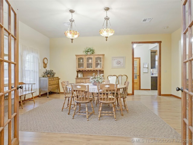 5792 W Lain Lake Rd, Atoka, OK 74525 - dining room featuring french doors, light wood finished floors, and baseboards