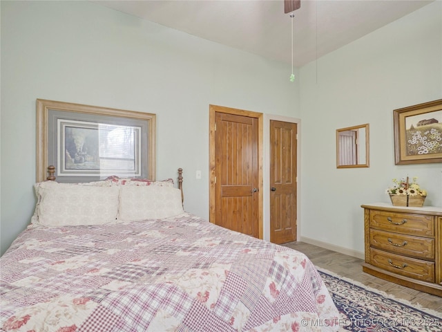 5792 W Lain Lake Rd, Atoka, OK 74525 - bedroom featuring a towering ceiling, baseboards, and a ceiling fan