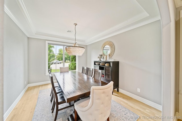 18319 E Red Fox Trl, Owasso, OK 74055 - dining room with a chandelier, light wood-type flooring, a raised ceiling, and crown molding