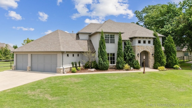 18319 E Red Fox Trl, Owasso, OK 74055 - french country home featuring stone siding, stucco siding, a garage, and concrete driveway