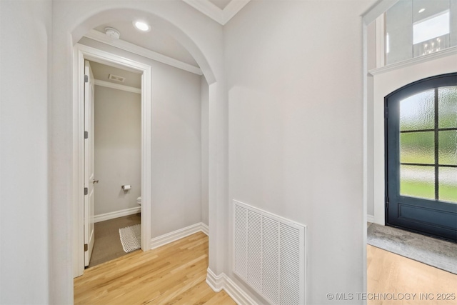 18319 E Red Fox Trl, Owasso, OK 74055 - corridor featuring wood finished floors, arched walkways, crown molding, and baseboards