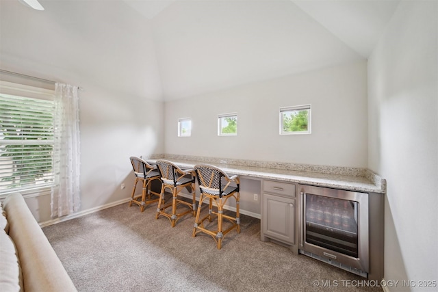 18319 E Red Fox Trl, Owasso, OK 74055 - office space featuring wine cooler, lofted ceiling, carpet flooring, and baseboards