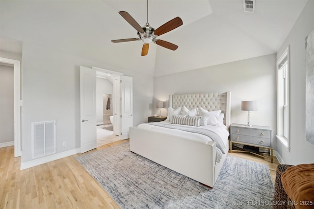 18319 E Red Fox Trl, Owasso, OK 74055 - bedroom with multiple windows, vaulted ceiling, wood finished floors, baseboards, and ensuite bathroom