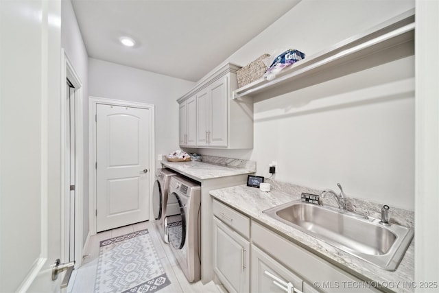18319 E Red Fox Trl, Owasso, OK 74055 - laundry area featuring washing machine and dryer, cabinet space, and light tile patterned floors