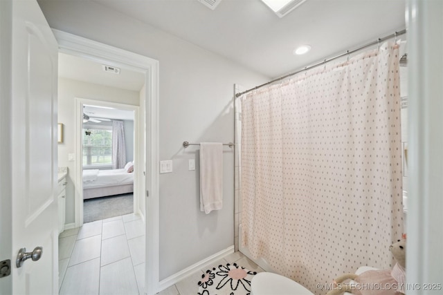 18319 E Red Fox Trl, Owasso, OK 74055 - ensuite bathroom featuring tile patterned flooring, baseboards, toilet, and shower / tub combo with curtain