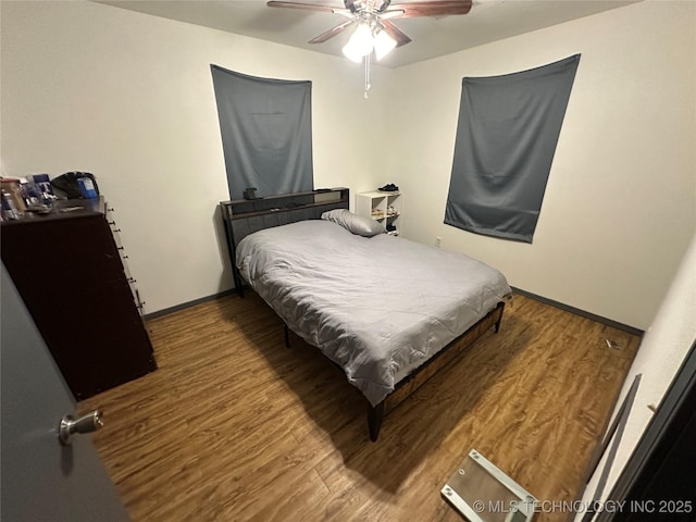 206 I St NE, Ardmore, OK 73401 - bedroom featuring wood finished floors, ceiling fan, and baseboards