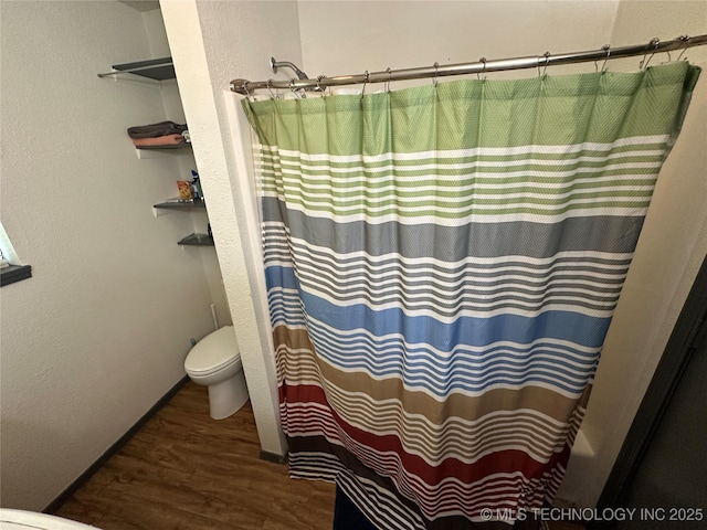 206 I St NE, Ardmore, OK 73401 - bathroom featuring toilet, wood finished floors, and a shower with curtain