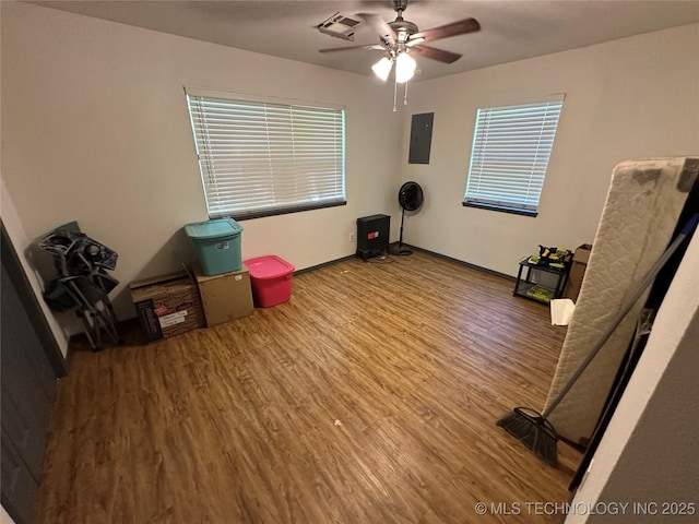 206 I St NE, Ardmore, OK 73401 - misc room featuring wood finished floors, ceiling fan, electric panel, baseboards, and plenty of natural light
