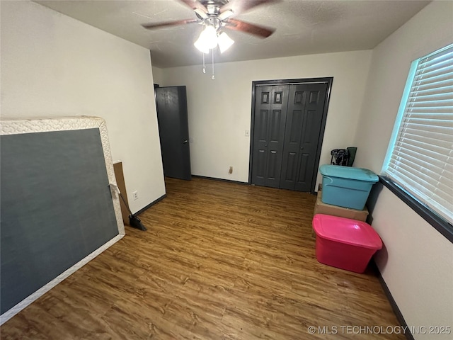 206 I St NE, Ardmore, OK 73401 - spare room with wood finished floors, ceiling fan, and baseboards