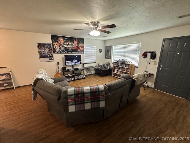 206 I St NE, Ardmore, OK 73401 - living room featuring wood finished floors, a ceiling fan, and baseboards