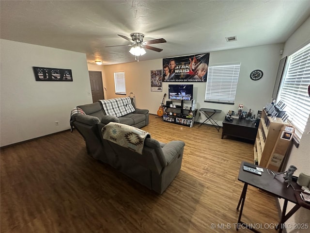 206 I St NE, Ardmore, OK 73401 - living room featuring wood finished floors, a ceiling fan, and baseboards