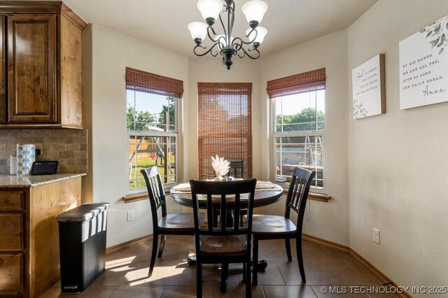 233 Murray Pl, Mannford, OK 74044 - dining area featuring healthy amount of natural light, a chandelier, baseboards, and dark tile patterned flooring