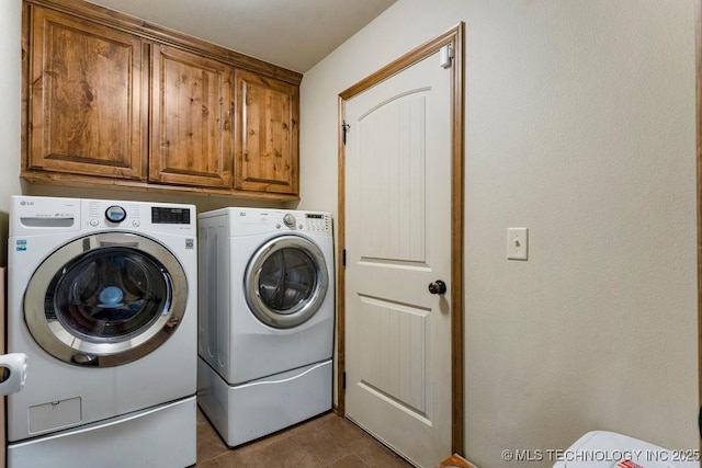 233 Murray Pl, Mannford, OK 74044 - washroom with washing machine and dryer, cabinet space, and dark tile patterned floors