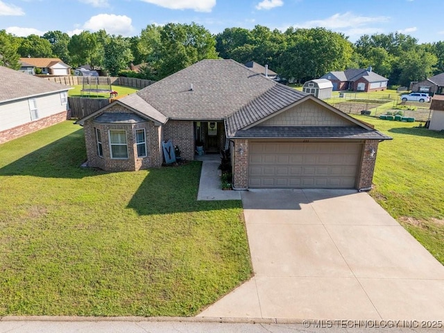 233 Murray Pl, Mannford, OK 74044 - view of front of house with brick siding, a front yard, a garage, and driveway