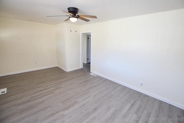 215 S Maple Ave, Tahlequah, OK 74464 - unfurnished room with wood finished floors, ceiling fan, and baseboards