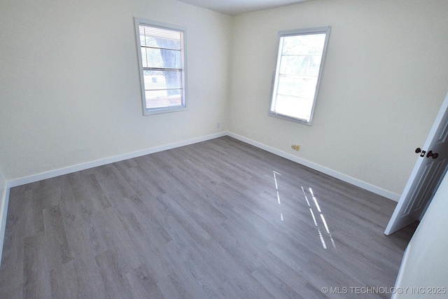 215 S Maple Ave, Tahlequah, OK 74464 - unfurnished room featuring dark wood-style flooring and baseboards