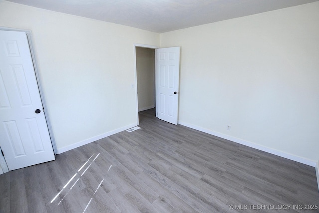 215 S Maple Ave, Tahlequah, OK 74464 - spare room featuring wood finished floors and baseboards