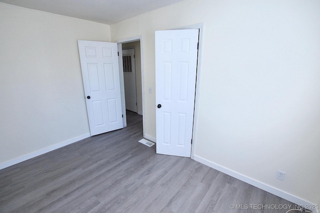 215 S Maple Ave, Tahlequah, OK 74464 - unfurnished room featuring wood finished floors and baseboards