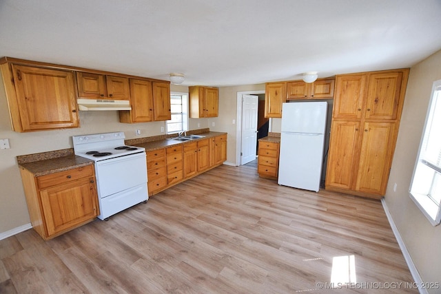 215 S Maple Ave, Tahlequah, OK 74464 - kitchen with white appliances, under cabinet range hood, a sink, and light wood finished floors