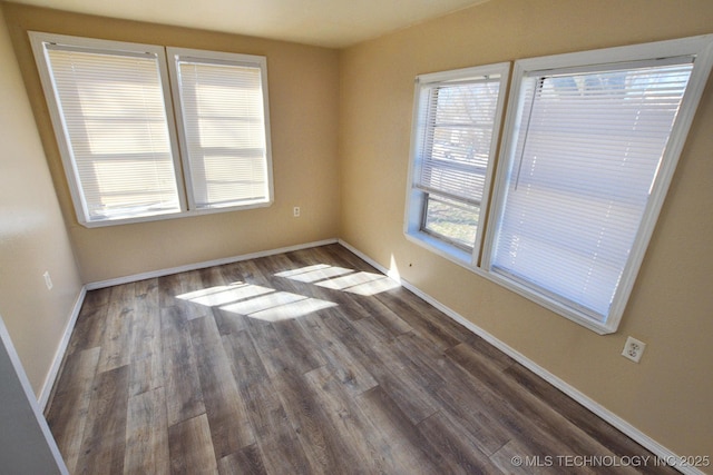 215 S Maple Ave, Tahlequah, OK 74464 - unfurnished room featuring dark wood-type flooring and baseboards