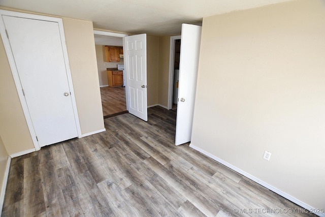 215 S Maple Ave, Tahlequah, OK 74464 - unfurnished bedroom with wood finished floors and baseboards