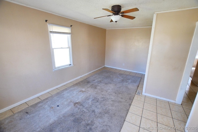 215 S Maple Ave, Tahlequah, OK 74464 - unfurnished room with light tile patterned floors, a ceiling fan, crown molding, a textured ceiling, and baseboards
