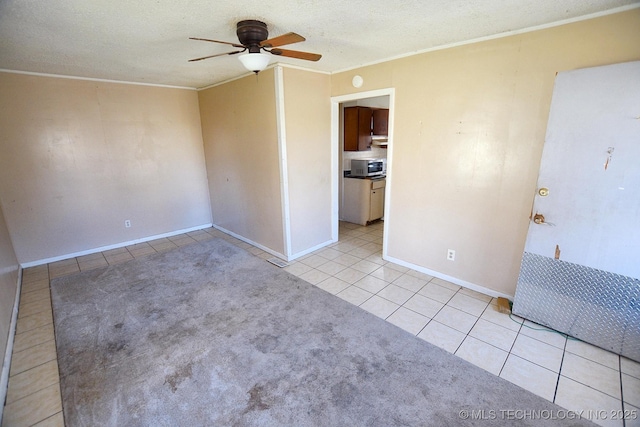 215 S Maple Ave, Tahlequah, OK 74464 - tiled empty room featuring ceiling fan, ornamental molding, and baseboards