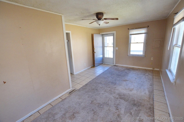 215 S Maple Ave, Tahlequah, OK 74464 - empty room featuring light tile patterned floors, a textured ceiling, a ceiling fan, ornamental molding, and baseboards