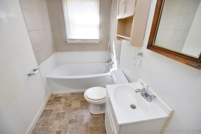 215 S Maple Ave, Tahlequah, OK 74464 - bathroom with toilet, stone finish floors, vanity, bathing tub / shower combination, and baseboards