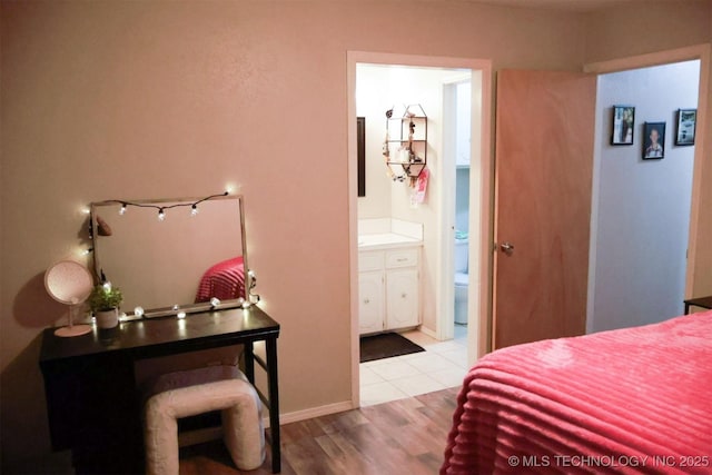 101 Honeysuckle Ln, Pryor, OK 74361 - bedroom featuring wood finished floors and ensuite bathroom