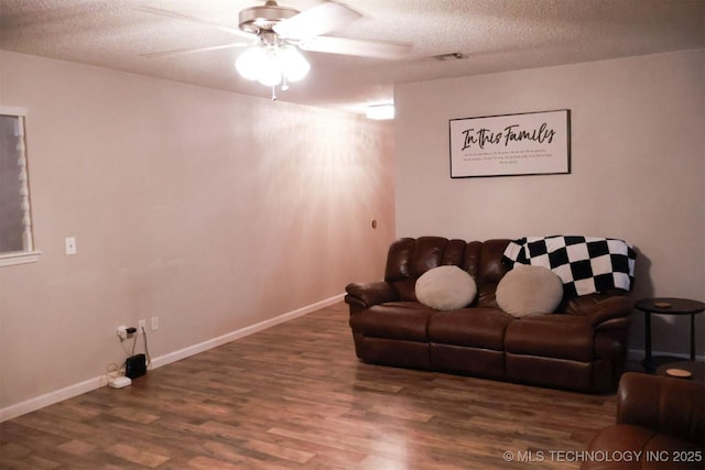 101 Honeysuckle Ln, Pryor, OK 74361 - living room featuring wood finished floors, a textured ceiling, a ceiling fan, and baseboards