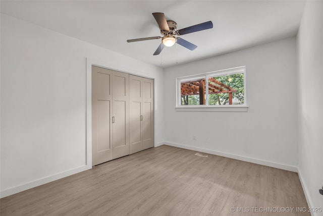 7362 S 68th E Ave, Tulsa, OK 74133 - unfurnished bedroom with light wood-style floors, baseboards, a closet, and a ceiling fan