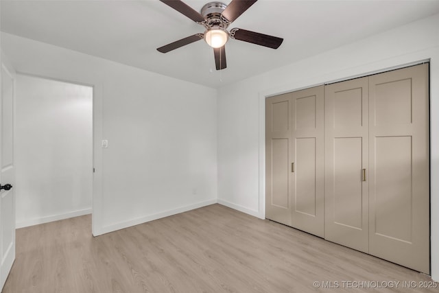 7362 S 68th E Ave, Tulsa, OK 74133 - unfurnished bedroom featuring wood finished floors, a closet, baseboards, and a ceiling fan