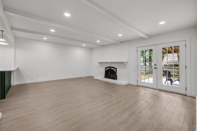 7362 S 68th E Ave, Tulsa, OK 74133 - unfurnished living room with beam ceiling, french doors, light wood-style floors, baseboards, and a fireplace