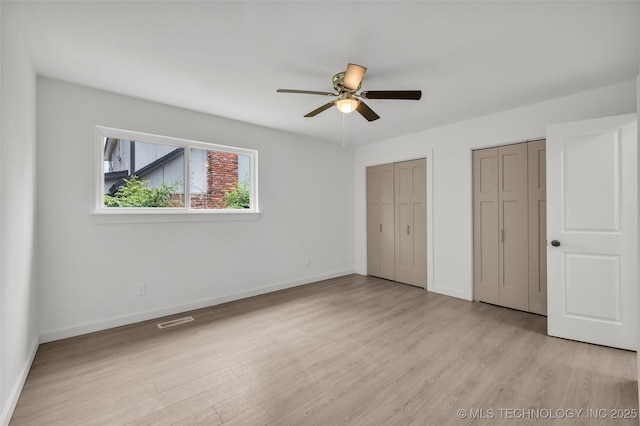 7362 S 68th E Ave, Tulsa, OK 74133 - unfurnished bedroom with two closets, light wood finished floors, baseboards, and ceiling fan