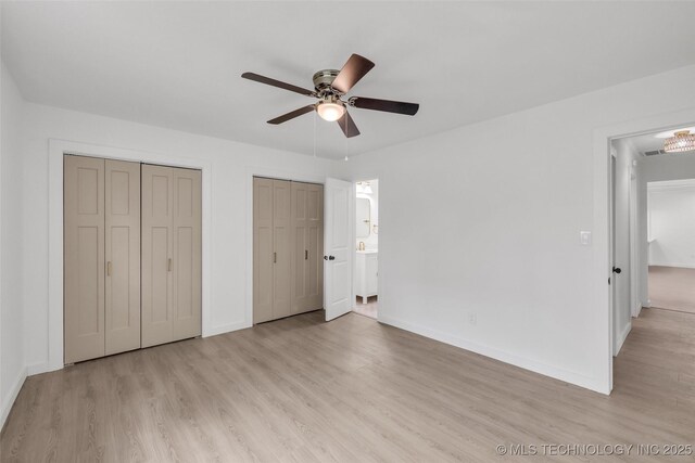 7362 S 68th E Ave, Tulsa, OK 74133 - unfurnished bedroom featuring light wood finished floors, multiple closets, baseboards, and ceiling fan