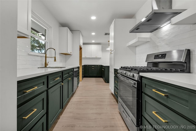 7362 S 68th E Ave, Tulsa, OK 74133 - kitchen with green cabinetry, stainless steel appliances, wall chimney range hood, a sink, and recessed lighting