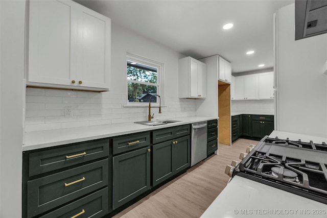 7362 S 68th E Ave, Tulsa, OK 74133 - kitchen with green cabinetry, dishwasher, a sink, white cabinets, and light wood-style flooring