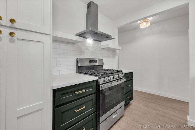7362 S 68th E Ave, Tulsa, OK 74133 - kitchen featuring green cabinetry, stainless steel range with gas cooktop, island range hood, light countertops, and decorative backsplash