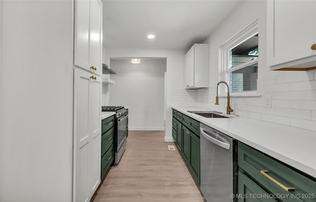 7362 S 68th E Ave, Tulsa, OK 74133 - kitchen with green cabinetry, gas range oven, dishwasher, a sink, and light countertops