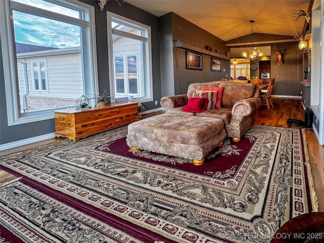 4418 N Little, Cushing, OK 74023 - living area featuring baseboards, wood finished floors, lofted ceiling, and a chandelier