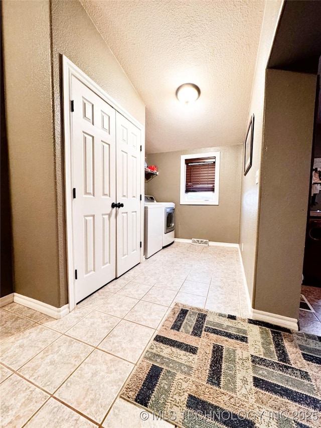 4418 N Little, Cushing, OK 74023 - washroom with washing machine and dryer, light tile patterned flooring, a textured ceiling, and baseboards