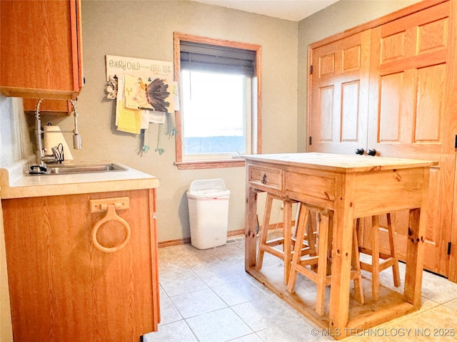 4418 N Little, Cushing, OK 74023 - bathroom featuring tile patterned flooring, a sink, and baseboards