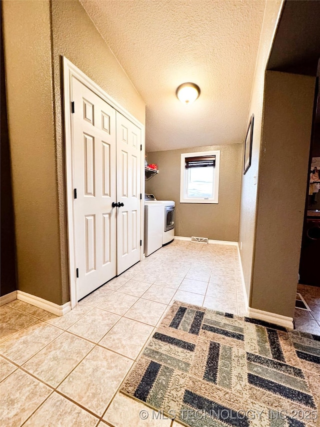 4418 N Little, Cushing, OK 74023 - washroom featuring separate washer and dryer, light tile patterned floors, a textured ceiling, and baseboards