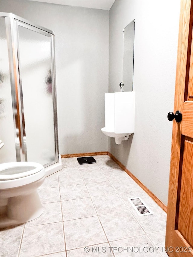 4418 N Little, Cushing, OK 74023 - full bathroom featuring toilet, a stall shower, and tile patterned floors