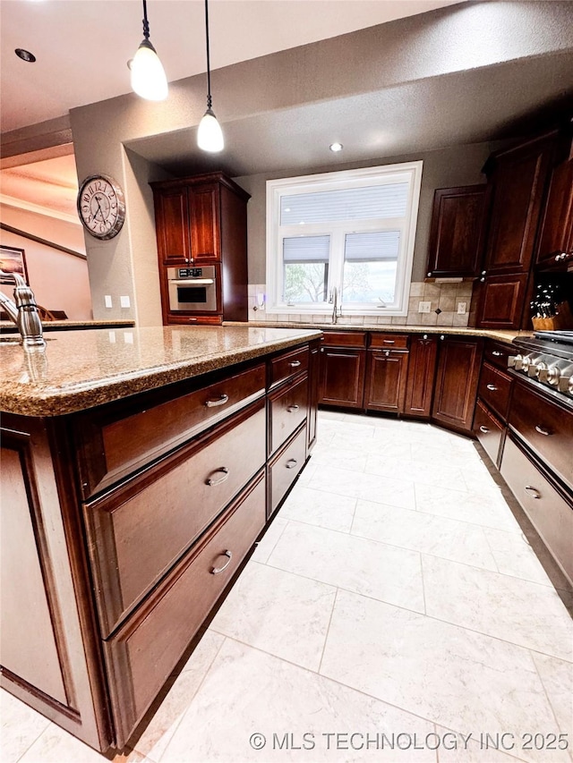 4418 N Little, Cushing, OK 74023 - kitchen with oven, light stone countertops, decorative backsplash, a sink, and hanging light fixtures