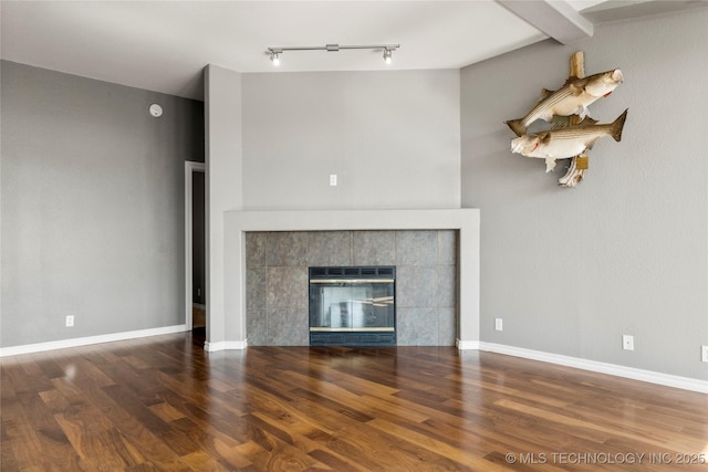 4418 N Little, Cushing, OK 74023 - unfurnished living room with wood finished floors, rail lighting, and a fireplace