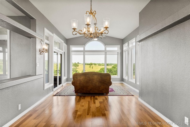 4418 N Little, Cushing, OK 74023 - living area with a textured wall, a chandelier, wood finished floors, and vaulted ceiling
